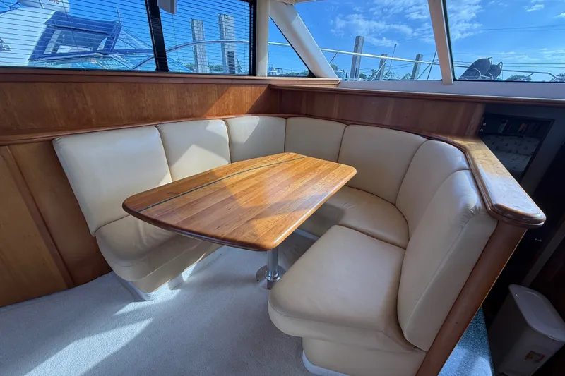 Slide: The Image of Luxurious interior of 2000 Silverton 42 Convertible yacht with plush seating and wooden table. - 17