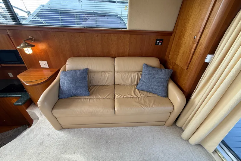 Slide: The Image of Beige leather sofa with blue cushions in 2000 Silverton 42 Convertible yacht interior. - 19