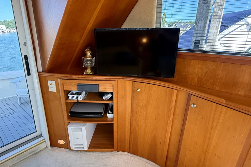 Slide: The Image of Interior of 2000 Silverton 42 Convertible yacht with TV and wooden cabinetry. - 20