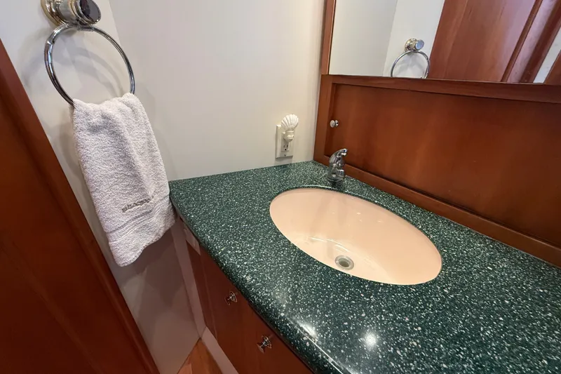 Slide: The Image of Luxurious bathroom sink in 2000 Silverton 42 Convertible yacht, featuring green countertop. - 44