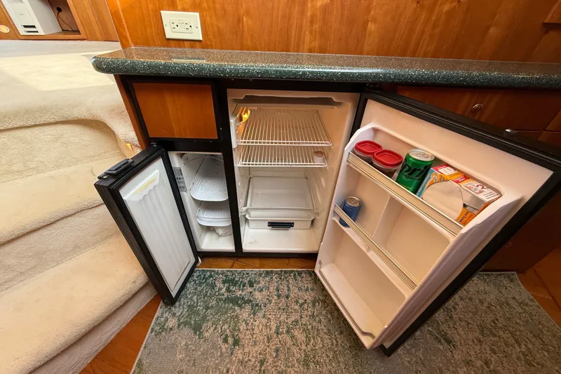 Slide: The Image of Small refrigerator inside a 2000 Silverton 42 Convertible yacht, stocked with drinks and snacks. - 30