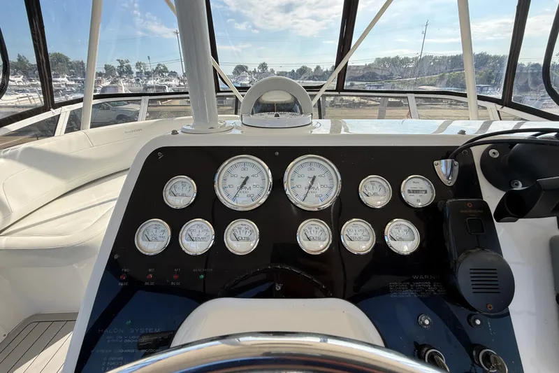 Slide: The Image of Dashboard of a 2000 Silverton 42 Convertible yacht with gauges and controls. - 53