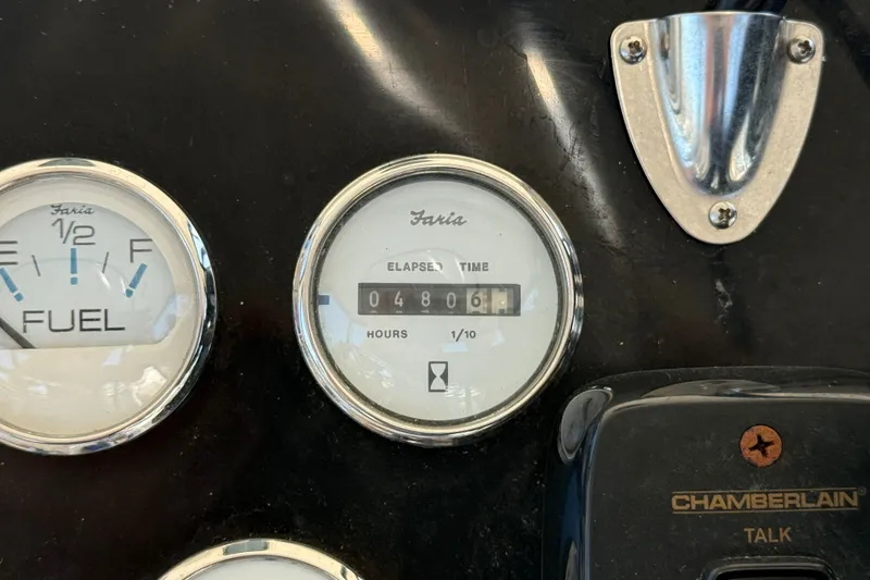 Slide: The Image of Dashboard gauges of a 2000 Silverton 42 Convertible boat, showing fuel and elapsed time. - 54