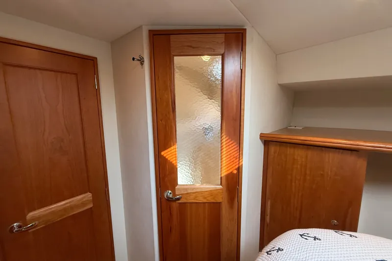 Slide: The Image of Interior of 2000 Silverton 42 Convertible yacht with wooden doors and cabinetry. - 39