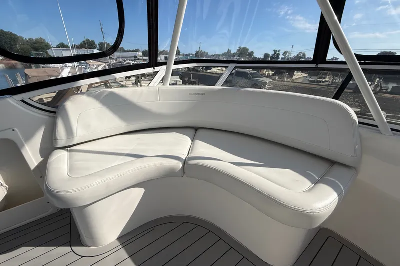 Slide: The Image of Luxurious seating on a 2000 Silverton 42 Convertible yacht, featuring sleek white upholstery. - 50