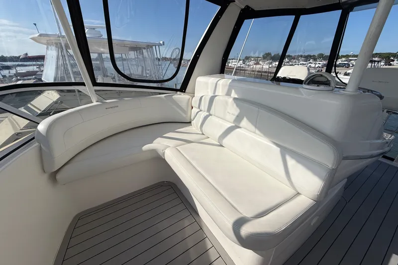 Slide: The Image of Luxurious seating area on a 2000 Silverton 42 Convertible yacht, featuring white upholstery. - 49