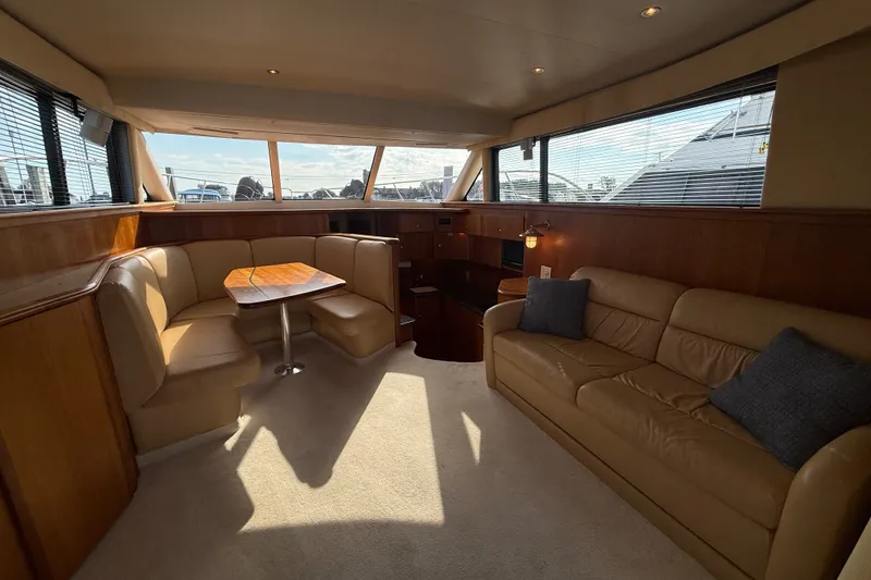 Slide: The Image of Luxurious interior of a 2000 Silverton 42 Convertible yacht with leather seating and wood accents. - 14