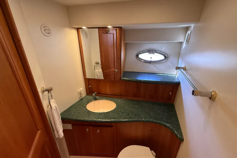 Slide: The Image of Luxurious bathroom in a 2000 Silverton 42 Convertible yacht with green countertop. - 42