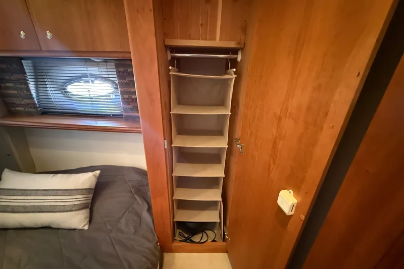 Slide: The Image of Interior of 2000 Silverton 42 Convertible yacht with storage and bed. - 34