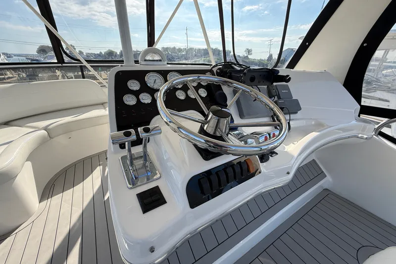 Slide: The Image of Helm of 2000 Silverton 42 Convertible yacht with steering wheel and control panel. - 52