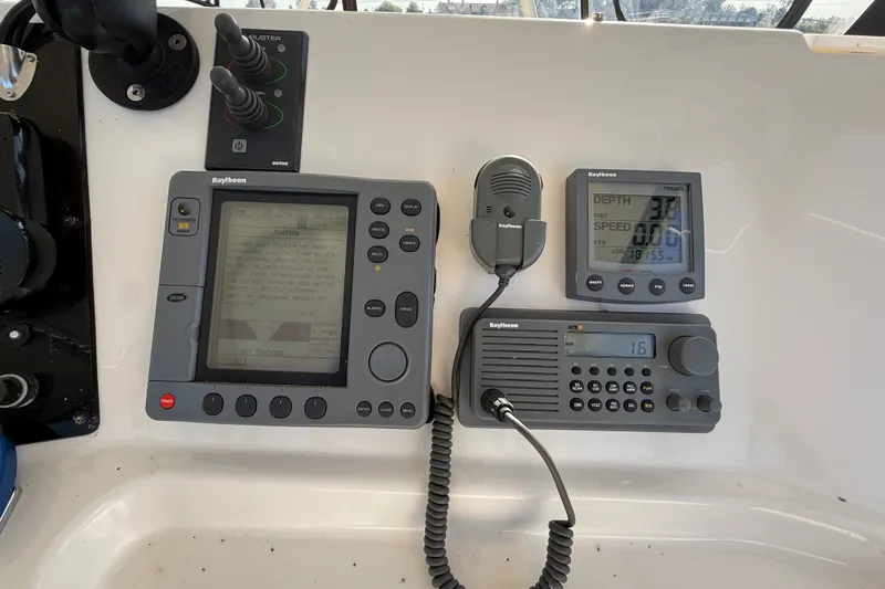 Slide: The Image of Control panel of a 2000 Silverton 42 Convertible boat with Raytheon navigation equipment. - 55