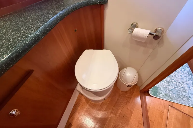 Slide: The Image of Bathroom interior of 2000 Silverton 42 Convertible yacht with toilet and countertop. - 45