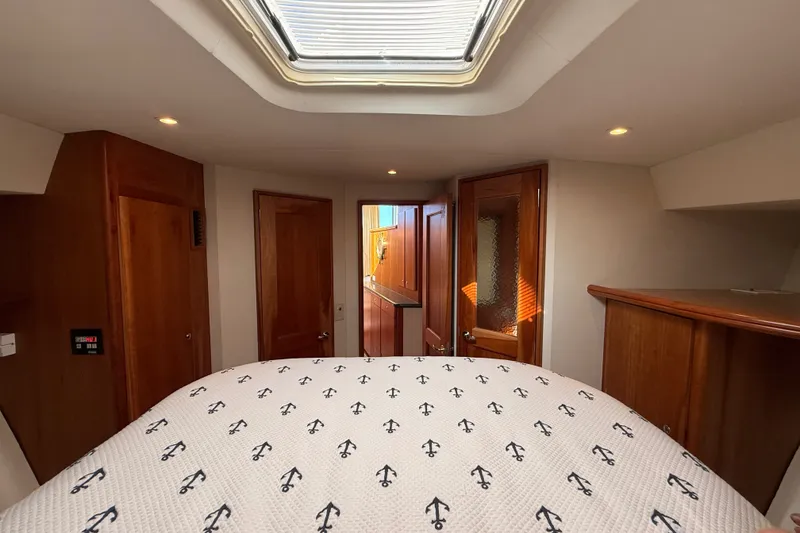 Slide: The Image of Interior cabin of 2000 Silverton 42 Convertible yacht with anchor-patterned bedding. - 38