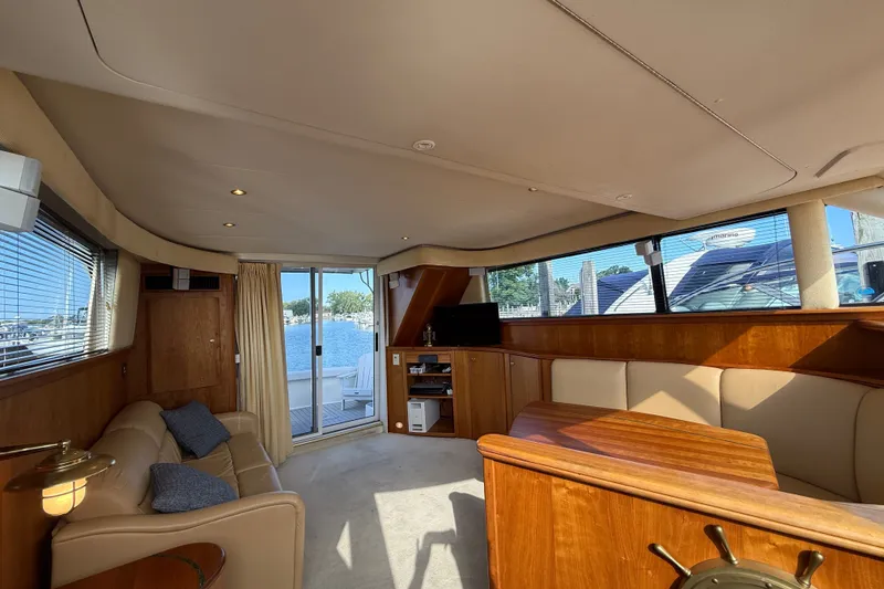 Slide: The Image of Luxurious interior of a 2000 Silverton 42 Convertible yacht with elegant wood finishes. - 46