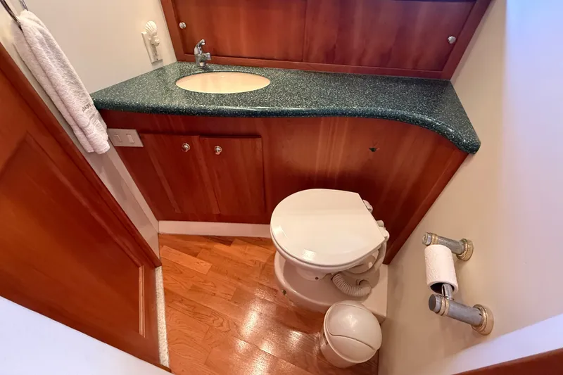 Slide: The Image of Luxurious bathroom in 2000 Silverton 42 Convertible yacht with wood cabinetry and modern fixtures. - 43