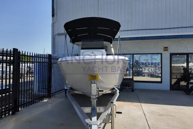Slide: The Image of A 2027 Stingray 17 CC boat on a trailer in front of a glass-fronted building. - 2