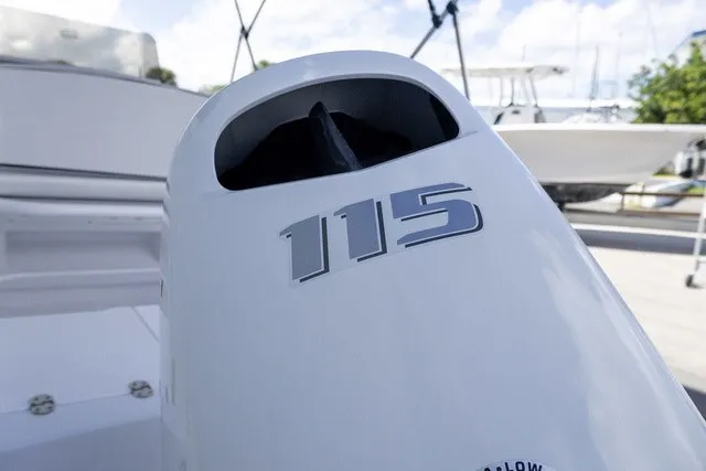 Slide: The Image of Close-up of an outboard motor labeled "115" on a boat. - 14