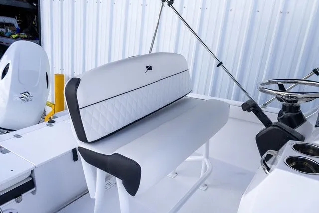 Slide: The Image of The image shows the cockpit of a Stingray 17 CC boat with white upholstery and a steering console. - 9