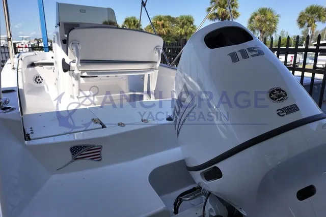 Slide: The Image of A modern 115 HP outboard motor is mounted on a white boat. Palm trees in the background. - 8