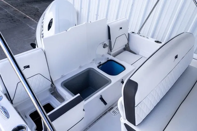 Slide: The Image of The image shows the cockpit of a 2027 Stingray 17 CC boat with white upholstery and an outboard motor. - 12