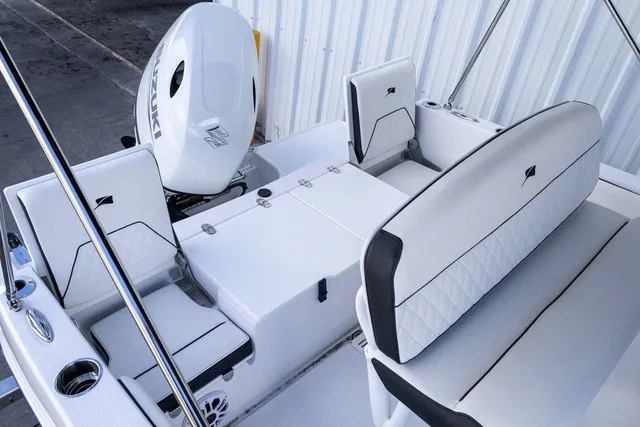 Slide: The Image of The image shows the cockpit of a Stingray 17 CC boat with white upholstery and an outboard motor. - 11