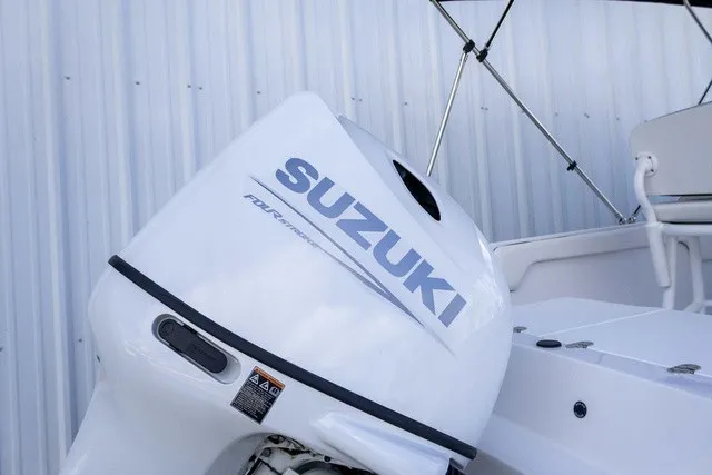 Slide: The Image of A Suzuki outboard motor on a Stingray 17 CC boat, year 2027, against a metal wall. - 15