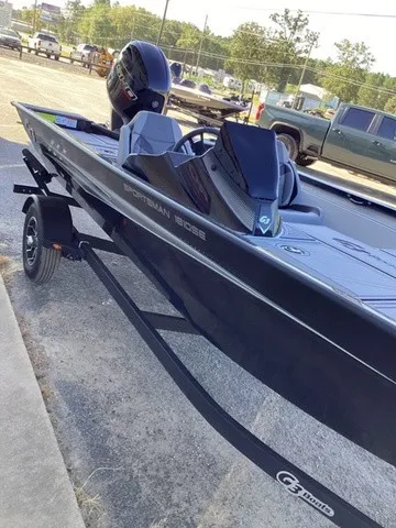 Slide: The Image of A black G3 Sportsman 1810 SE boat on a trailer, parked in a lot. - 26