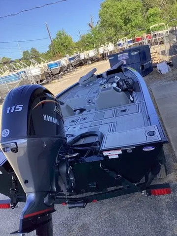 Slide: The Image of A G3 Sportsman 1810 SE boat with a Yamaha 115 engine, parked on a trailer. - 35