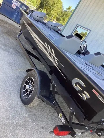 Slide: The Image of A black G3 Sportsman 1810 SE boat on a trailer, featuring gray seats and a steering wheel. - 8