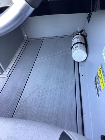 Slide: The Image of The image shows a boat floor with gray wood-like finish and a fire extinguisher on the side. - 31