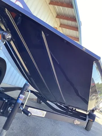 Slide: The Image of A 2026 G3 Sportsman 1810 SE boat on a trailer, parked in front of a building. - 17