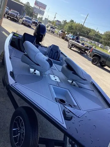 Slide: The Image of A modern 2026 G3 Sportsman 1810 SE on a trailer. It features two seats and a sleek design. - 22