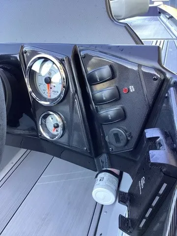 Slide: The Image of The image shows the dashboard of a G3 Sportsman 1810 SE with gauges and switches. - 32