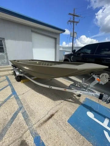Slide: The Image of A G3 Gator Tough 1652 VBW boat on a trailer, parked in a lot next to a building. - 10