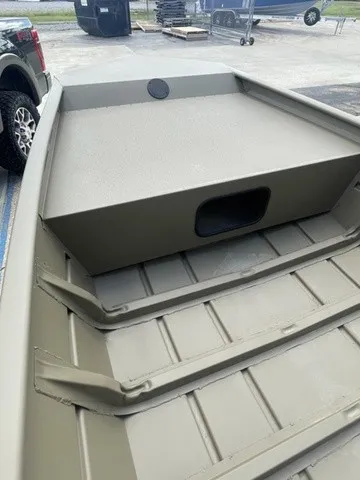 Slide: The Image of The image shows the interior of a sturdy aluminum boat with a flat platform and grooves. - 6