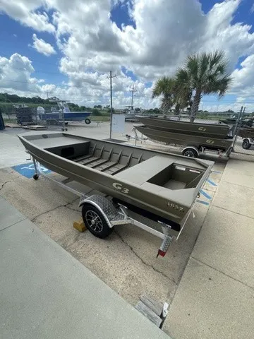 Slide: The Image of A G3 Gator Tough 1652 VBW boat on a trailer, surrounded by palm trees and a cloudy sky. - 4