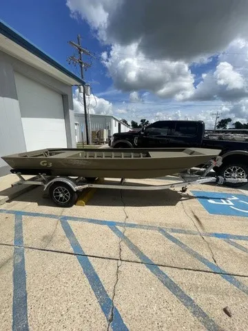 Slide: The Image of A G3 Gator Tough 1652 VBW boat on a trailer, parked in a lot under sunny skies. - 11