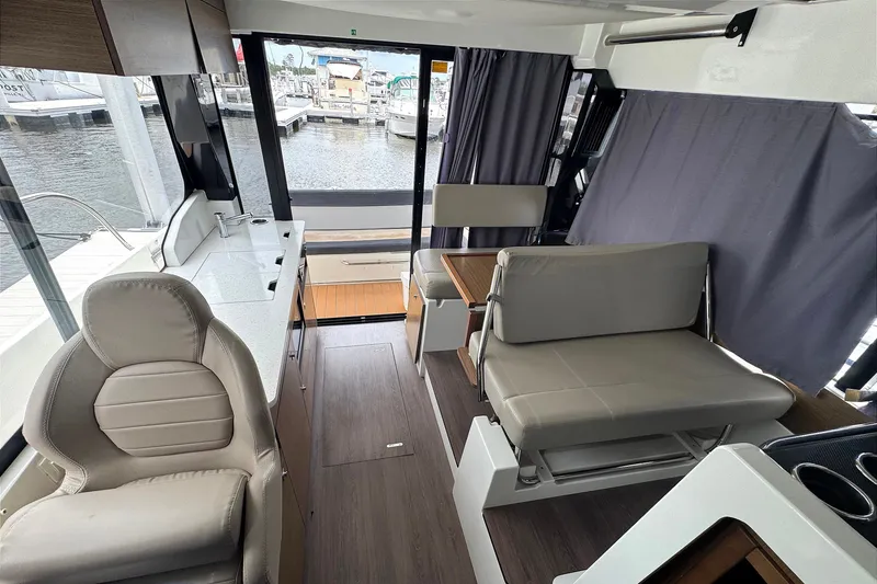 Slide: The Image of Interior of 2021 Jeanneau NC Weekender 1095 boat with seating and water view. - 28