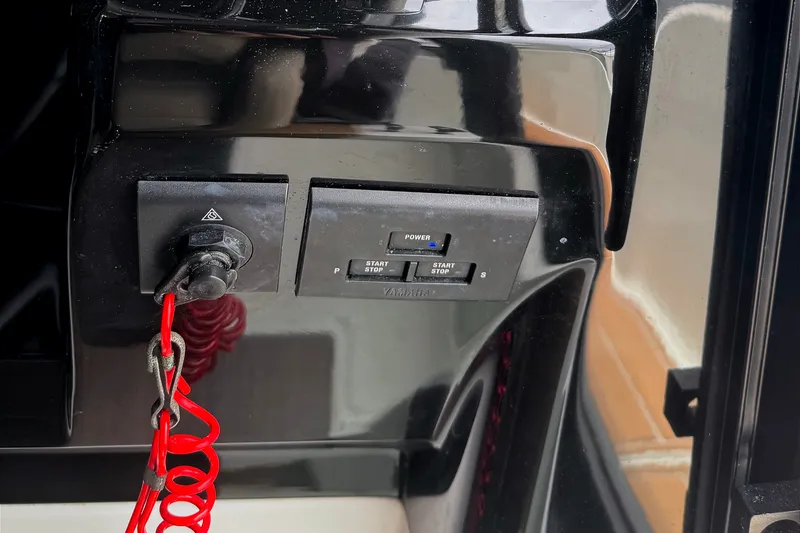 Slide: The Image of Control panel of a 2021 Jeanneau NC Weekender 1095 boat with ignition key and red safety cord. - 33