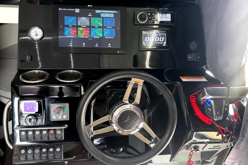 Slide: The Image of Control panel of a 2021 Jeanneau NC Weekender 1095 boat with modern navigation displays. - 32