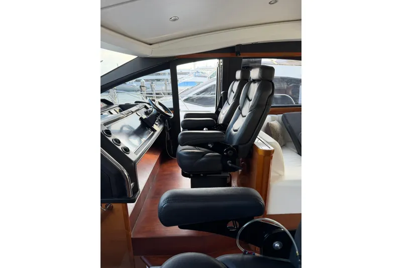Slide: The Image of Interior of 2005 Princess V70 yacht with luxurious black leather seating. - 10