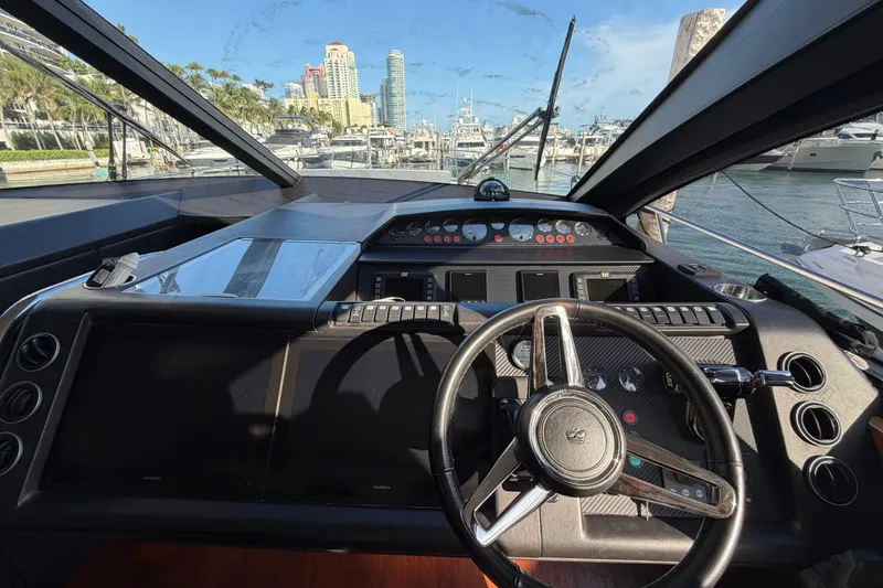 Slide: The Image of Interior view of 2005 Princess V70 yacht cockpit with steering wheel and control panels. - 16