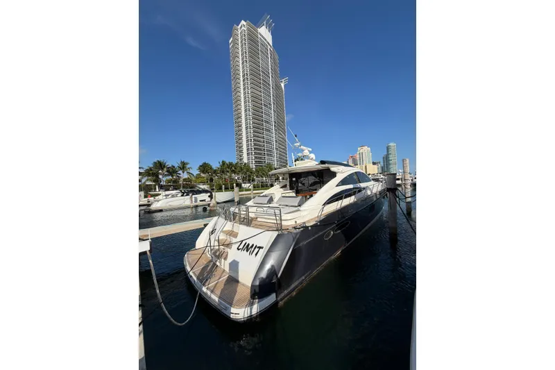 Slide: The Image of Luxury 2005 Princess V70 yacht docked in a marina with city skyline backdrop. - 2