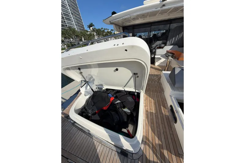 Slide: The Image of Open storage compartment on 2005 Princess V70 yacht deck with bags inside. - 14