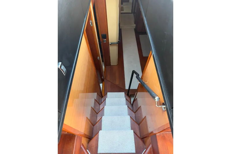 Slide: The Image of Staircase inside 2005 Princess V70 yacht, featuring wooden steps and modern design. - 11
