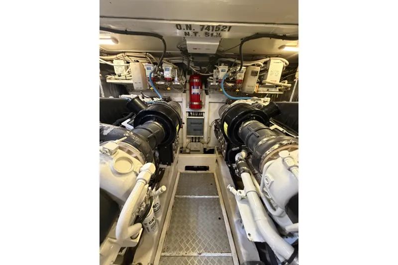 Slide: The Image of Engine room of a 2005 Princess V70 yacht, featuring dual engines and equipment. - 13