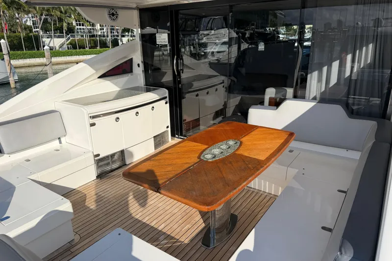 Slide: The Image of Luxurious 2005 Princess V70 yacht deck with elegant wooden table and seating area. - 9