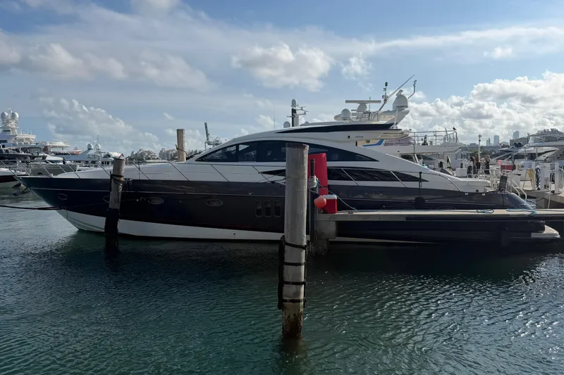 The Image of Luxury 2005 Princess V70 yacht docked at marina under blue sky. - 1