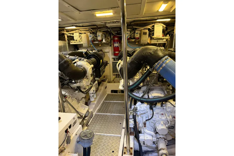 Slide: The Image of Engine room of a 2005 Princess V70 yacht, featuring dual engines and mechanical components. - 3