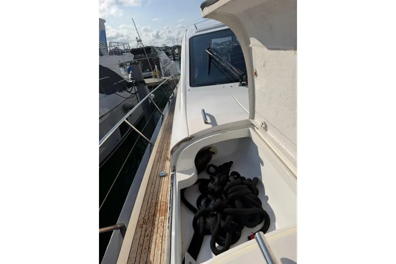Slide: The Image of 2005 Princess V70 yacht deck with open storage compartment and coiled rope. - 15